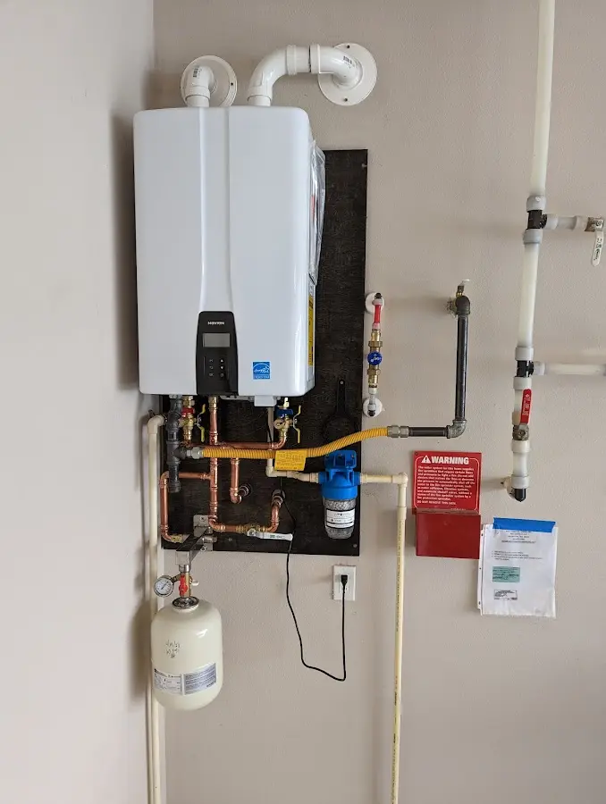 Professional plumber installing copper piping in a Bigfork home